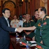 Chủ tịch nước Trương Tấn Sang và các cựu chiến binh Sư đoàn 324 thuộc Bộ Quốc phòng. (Ảnh: Nguyễn Khang/TTXVN)