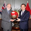 Phó Thủ tướng Vũ Văn Ninh trao tặng quà lưu niệm với Huân tước David Terence Puttnam. (Ảnh: Như Mai/TTXVN)