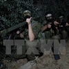 Các thành viên Lữ đoàn al-Qassam, một cánh vũ trang của phong trào Hamas tham gia huấn luyện tại Dải Gaza. (Nguồn: THX/TTXVN)