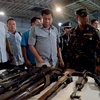 Tổng thống Rodrigo Duterte (giữa) kiểm tra số vũ khí trái phép quân đội Philippines tịch thu trong các chiến dịch truy quét khủng bố tại thành phố Cagayan de Oro, miền nam Philippines ngày 9/8 vừa qua. (Ảnh: EPA/TTXVN)