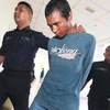 Mohd Afiq Abdullah đang bị cảnh sát dẫn giải (Nguồn: Nst.com.my)