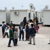 Trẻ em nhập cư tại trại tị nạn. (Ảnh: AFP/TTXVN)