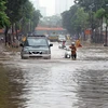 Mưa lớn gây ngập sâu tại khu vực đường Thái Hà mới ở quận Đống Đa gây ảnh hưởng đến đến việc đi lại của người dân. (Ảnh: Quang Quyết/TTXVN)