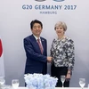 Thủ tướng Nhật Bản Shinzo Abe và người đồng cấp Vương quốc Anh Theresa May. (Nguồn: PA)