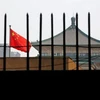 Quốc kỳ của Trung Quốc rực rỡ sau hàng rào của trụ sở của Ủy ban Cải cách và Phát triển quốc gia (NDRC) ở Bắc Kinh. (Nguồn: Reuters)