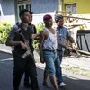 Cảnh sát bắt giữ một đối tượng tình nghi để thẩm vấn sau vụ tấn công ở Surabaya, Indonesia ngày 14/5 vừa qua. (Ảnh: AFP/TTXVN)