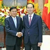 Chủ tịch nước Trần Đại Quang (phải) trong cuộc gặp Thủ tướng Lào Thongloun Sisoulith (trái), có chuyến thăm Việt Nam, tại Hà Nội ngày 30/3 vừa qua. (Ảnh: AFP/TTXVN) 