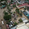 Cảnh ngập lụt tại thị trấn Baao, tỉnh Camarines Sur, Philippines, ngày 30/12. (Ảnh: AFP/TTXVN)
