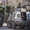 Lực lượng an ninh tuần tra tại làng al-Rawda, Bắc Sinai của Ai Cập, ngày 26/7/2018. (Ảnh: AFP/TTXVN)