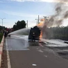 Lực lượng cảnh sát Phòng cháy chữa cháy chữa cháy xe bồn chở dầu biể kiểm soát AX-1026 tại hiện trường. (Ảnh: TTXVN phát)