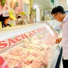 Người tiêu dùng mua thịt lợn tại siêu thị coopmart. (Ảnh: Đỗ Phương Anh/TTXVN)