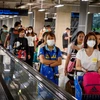 Hành khách đeo khẩu trang phòng lây nhiễm bệnh viêm đường hô hấp cấp COVID-19 tại sân bay ở Bangkok, Thái Lan. (Ảnh: AFP/TTXVN)