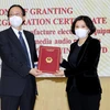 Chủ tịch UBND tỉnh Bắc Ninh Nguyễn Hương Giang (phải) trao Giấy chứng nhận đầu tư cho Công ty Goertek Vina. (Ảnh: Đinh Văn Nhiều/TTXVN)
