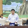 Bộ trưởng Bộ Kế hoạch và Đầu tư Nguyễn Chí Dũng trình bày tờ trình. (Ảnh: Doãn Tấn/TTXVN)