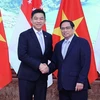 Thủ tướng Phạm Minh Chính và Chủ tịch Quốc hội Singapore Tan Chuan-Jin. (Ảnh: Dương Giang/TTXVN)