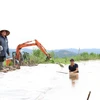 Người dân xã Buôn Triết, huyện Lắk gia cố những đoạn đê bị hư hỏng để ngăn nước sông Krông Ana tràn vào cách đồng. (Ảnh: Tuấn Anh/TTXVN)