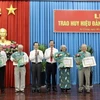 Ông Lê Hồng Quang, Bí thư Tỉnh ủy An Giang trao Huy hiệu 60 năm tuổi Đảng cho các đảng viên. (Ảnh: Thanh Sang/TTXVN)