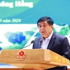 Bộ trưởng Bộ Kế hoạch và Đầu tư Nguyễn Chí Dũng báo cáo kết quả triển khai Quy hoạch vùng Đồng bằng sông Hồng. (Ảnh: Dương Giang/TTXVN)