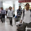 Lao động Việt Nam đi làm việc ở nước ngoài trở về. (Ảnh: TTXVN)