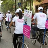 Các em học sinh tham gia đạp xe, phát tờ rơi với thông điệp thành phố an toàn cho trẻ em gái. (Nguồn: Plan International Việt Nam) 