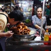 Nhiều món ăn độc đáo được bầy bán tại khu chợ (Ảnh: Lâm Phan/Vietnam+) 