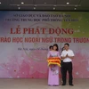 Ông Trần Trọng Hưng, Phó trưởng Ban Đề án Ngoại ngữ quốc gia 2020 tặng sách ngoại ngữ cho Trường Trung học phổ thông Yên Hòa. (Ảnh: PV/Vietnam+)