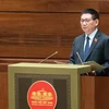 Bộ trưởng Bộ Tài chính Hồ Đức Phớc trình bày Tờ trình dự thảo Nghị quyết về việc áp dụng thuế thu nhập doanh nghiệp bổ sung theo quy định chống xói mòn cơ sở thuế toàn cầu. (Ảnh: CTV/Vietnam+)