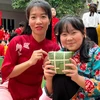 Học sinh Trường Trung học Cơ sở - Trung học Phổ thông Newton cơ sở 1 tự tay gói bánh dành tặng các bạn nhỏ Làng trẻ Hòa Bình. (Ảnh: PV/Vietnam+)