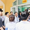 Bộ trưởng Nguyễn Kim Sơn động viên thí sinh trước khi bước vào phòng thi. (Ảnh: PV/Vietnam+)