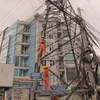 Tình trạng vi phạm hành lang an toàn lưới điện cao áp vẫn diễn ra phổ biến trên địa bàn Hà Nội (Ảnh: Đức Duy/Vietnam+)