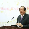 Bộ trưởng Chủ nhiệm Văn phòng Chính phủ Mai Tiến Dũng đang trả lời họp báo. (Ảnh: PV/Vietnam+)