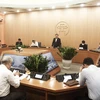 Cuộc họp của Ban Chỉ đạo phòng, chống dịch COVID-19 với các quận, huyện ngày 25/3. (Ảnh: PV/Vietnam+)
