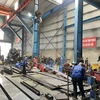 Hoạt động sản xuất kinh doanh tại cụm công nghiệp Phùng Xá. (Ảnh: PV/Vietnam+)