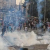 Quang cảnh cuộc đụng độ giữa người ném đá Palestine và binh sỹ Irael tại thành phố Bethlehem, Bờ Tây ngày 23/10. (Nguồn: THX/TTXVN)