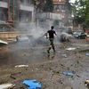 Hiện trường một vụ tấn công bằng rocket nhằm vào khu dân cư ở Aleppo làm 11 người thiệt mạng, 37 người bị thương ngày 3/5. (Nguồn: EPA/TTXVN)