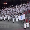 Đoàn vận động viên Hàn Quốc và Triều Tiên cùng diễu hành chung dưới lá cờ thống nhất Triều Tiên tại lễ khai mạc Olympic PyeongChang 2018. (Nguồn: AFP/TTXVN)