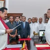 Tổng thống Sri Lanka Maithripala Sirisena (phải) chứng kiến lễ tuyên thệ nhậm chức Thủ tướng mới của ông Mahinda Rajapakse (trái) tại Colombo ngày 26/10. (Nguồn: AFP/TTXVN) 