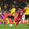 Pha ghi bàn của cầu thủ Việt Nam Phạm Đức Huy vào lưới Malaysia trong trận lượt đi chung kết AFF Suzuki Cup 2018, Kuala Lumpur, Malaysia ngày 11/12/2018. (Nguồn: AFP/TTXVN) 