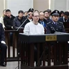 Công dân Canada Robert Lloyd Schellenberg (giữa) tại phiên xét xử của Tòa án ở thành phố Đại Liên, tỉnh Liêu Ninh, Đông Bắc Trung Quốc ngày 14/1/2019. (Nguồn: AFP/TTXVN) 