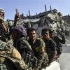 Các thành viên Lực lượng Dân chủ Syria sau chiến dịch truy quét các tay súng Tổ chức Nhà nước Hồi giáo (IS) tự xưng tại thành phố Raqa, miền Bắc Syria ngày 20/10/2017. (Nguồn: AFP/TTXVN) 