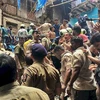 Lực lượng cứu hộ tìm kiếm nạn nhân bị mắc kẹt dưới đống đổ nát của tòa nhà bị sập ở Mumbai, Ấn Độ ngày 16/7/2019. (Nguồn: India Express/TTXVN) 