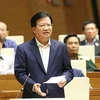 Phó Thủ tướng Chính phủ Trịnh Đình Dũng trả lời những chất vấn thuộc trách nhiệm của Chính phủ. (Ảnh: Doãn Tấn/TTXVN) 