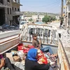 Người dân sơ tán khỏi các khu vực chiến sự ở Idlib. (Nguồn: AFP/TTXVN) 