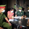 Lực lượng Đồn Biên phòng Hồ Le và Công an xã Ia Dal, huyện Ia H’Drai (Kom Tum) tuyên truyền, vận động người dân ký cam kết thực hiện các biện pháp phòng dịch COVID-19 và xuất, nhập cảnh trái phép. (Ảnh: Khoa Chương/TTXVN) 