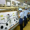 Sản xuất linh kiện điện tử tại Công ty TNHH Điện-Điện tử Mê Trần Vĩnh Phúc. (Ảnh: Danh Lam/TTXVN) 