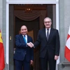 Chủ tịch nước Nguyễn Xuân Phúc và Tổng thống Liên bang Thụy Sĩ Guy Parmelin. (Ảnh: Thống Nhất/TTXVN) 