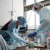 Nhân viên y tế điều trị cho bệnh nhân COVID-19 tại bệnh viện ở Sapporo, Nhật Bản. (Ảnh: AFP/TTXVN) 