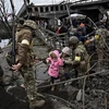 Người dân sơ tán khỏi thành phố Irpin, tây bắc thủ đô Kiev, Ukraine, ngày 5/3/2022. (Ảnh: AFP/TTXVN) 