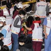 Nhân viên y tế hỗ trợ nạn nhân tại hiện trường vụ giẫm đạp trong lễ Halloween ở Itaewon, Seoul, Hàn Quốc ngày 30/10/2022. (Ảnh: Yonhap/TTXVN) 