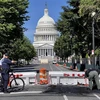 Cảnh sát điều tra tại hiện trường vụ nổ súng gần Đồi Capitol ở Washington, DC, Mỹ ngày 14/8/2022. (Ảnh: AFP/TTXVN) 